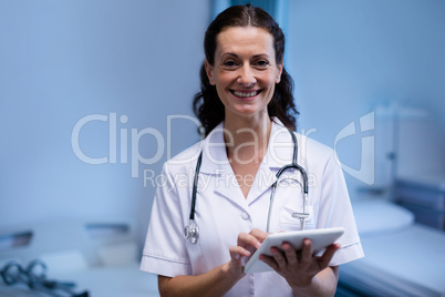 Portrait of female doctor using digital tablet in ward
