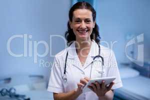 Portrait of female doctor using digital tablet in ward
