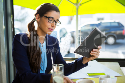 Business executive using digital tablet in cafÃ?Â©