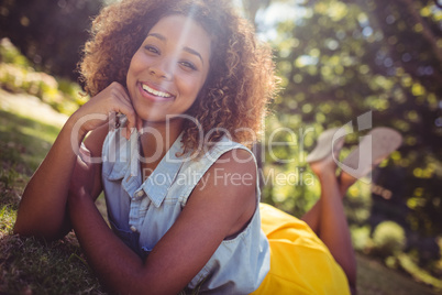Smiling woman lying on a grass
