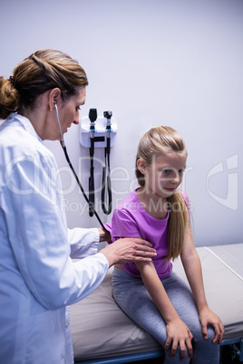 Doctor examining a patient with stethoscope