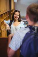 Happy students interacting with each other in locker room