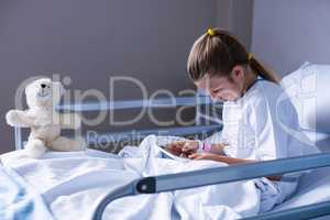 Patient using digital tablet in ward