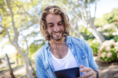 Happy man using digital tablet