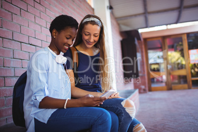 Schoolgirls using mobile phone