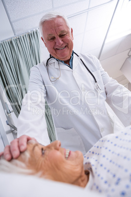 Doctor consoling senior patient