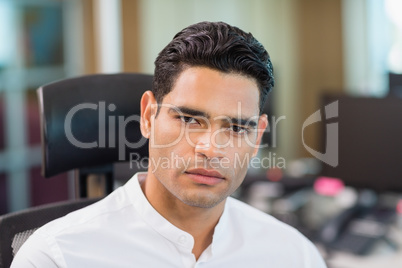 Portrait of serious business executive sitting on chair