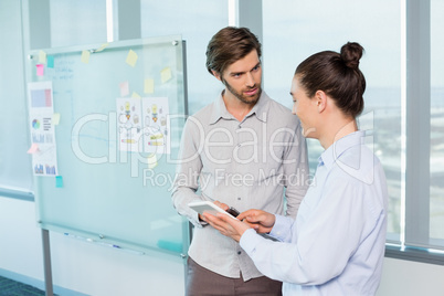 Business executives discussing over digital tablet