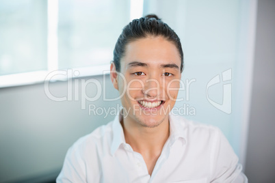 Smiling business executive sitting in office