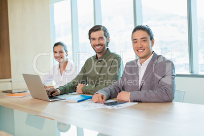 Smiling business team sitting in conference room