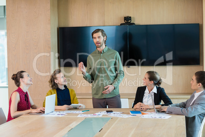 Business executive giving presentation to colleagues