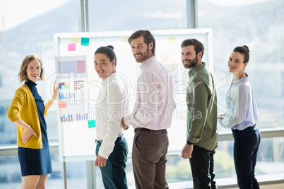 Smiling business executives standing in office