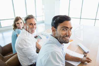 Smiling architects sitting together in office