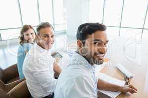 Smiling architects sitting together in office