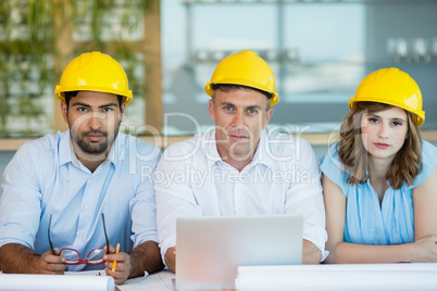 Architects sitting together in conference room