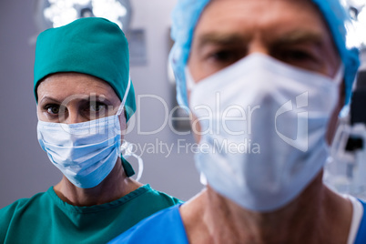 Portrait of surgeons wearing surgical mask in operation theater