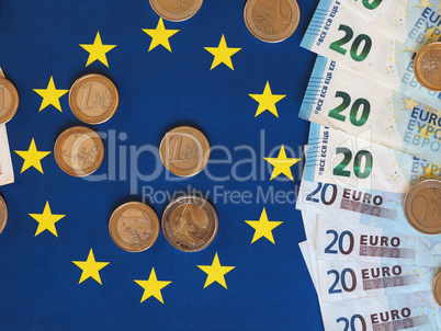 Euro notes and coins, European Union, over flag