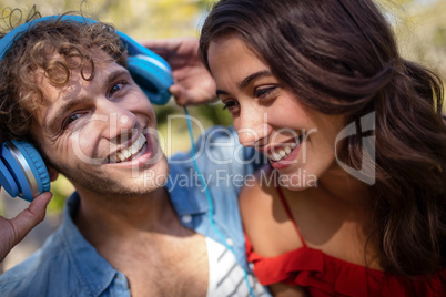 Couple listening to music in park