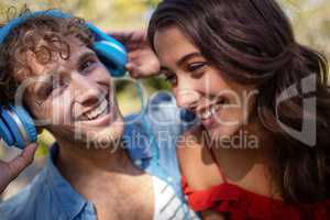 Couple listening to music in park