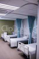 View of empty hospital beds in ward