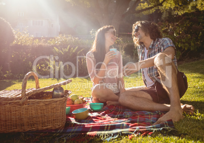 Happy couple having picnic in the park