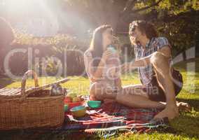 Happy couple having picnic in the park