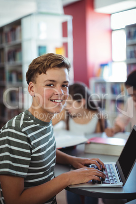 Attentive student using laptop in library