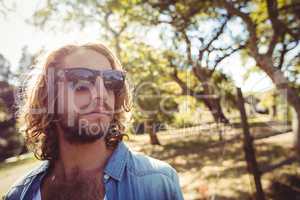 Man in sunglasses standing in park