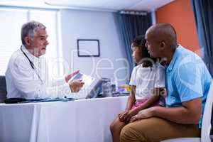 Doctor using digital tablet while interacting with patient