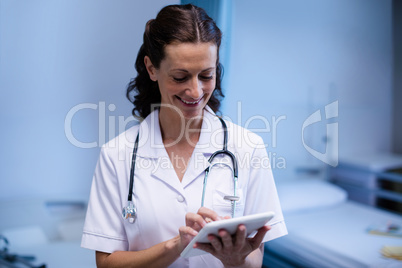 Female doctor using digital tablet in ward