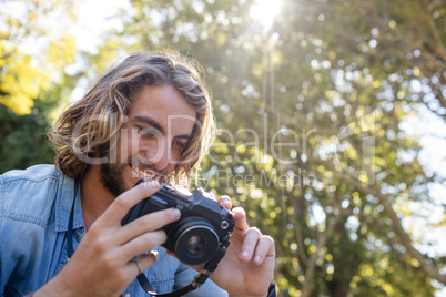 Happy man looking at photos on digital camera
