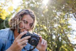 Happy man looking at photos on digital camera