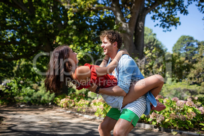 Man carrying woman in park