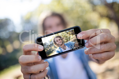 Man taking picture of himself on mobile phone