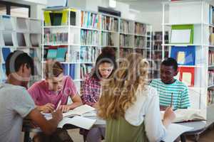 Attentive classmates studying in library