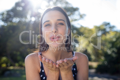 Portrait of woman blowing kiss