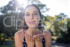 Portrait of woman blowing kiss