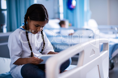 Patient sitting with digital tablet