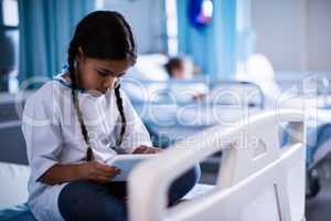 Patient sitting with digital tablet