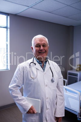 Portrait of male doctor standing in ward