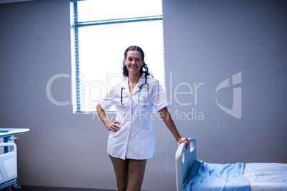 Portrait of female doctor standing in ward