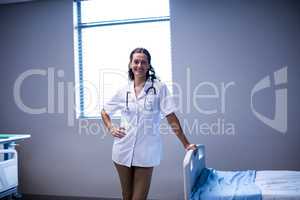 Portrait of female doctor standing in ward