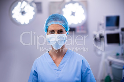 Portrait of female nurse wearing surgical mask in operation theater