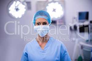 Portrait of female nurse wearing surgical mask in operation theater