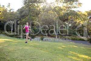 Female jogger listening to music while jogging