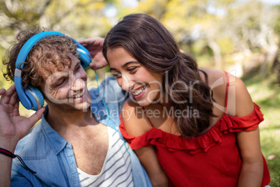 Couple listening to music in park