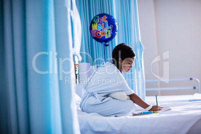 Girl drawing picture in a book