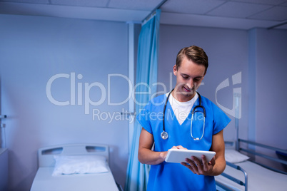 Doctor using digital tablet in ward