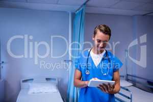 Doctor using digital tablet in ward