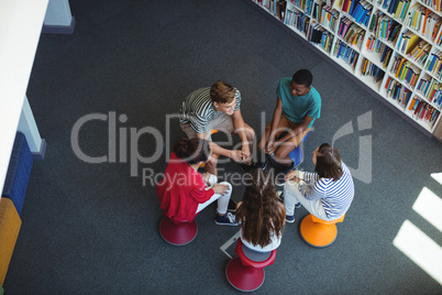 Students interacting with each other in library
